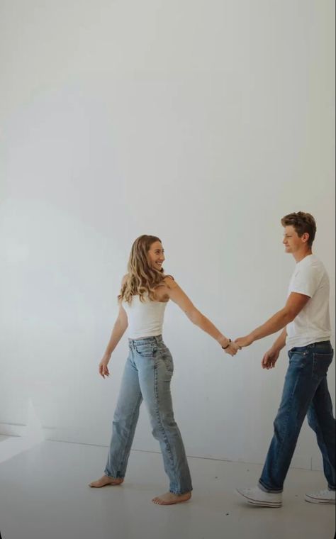 White Sheet Couples Shoot, White Tshirt Photoshoot Couple, White Backdrop Couple Photoshoot, Engagement Photo Studio Ideas, Carrying Girlfriend Over Shoulder, Jeans And Tshirt Couple Photoshoot, White Tee And Jeans Photoshoot Couple, Engagement Photos Indoor Studio, White T Shirt Engagement Photos