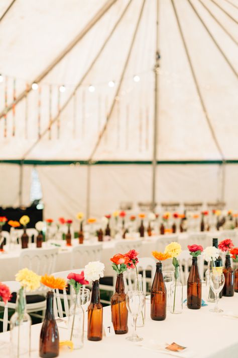 Bohemian Origami Marquee Wedding in Guernsey Flowers In Beer Bottles Wedding, Beer Bottle Wedding Decor, Beer Bottle Wedding, Beer Bottle Centerpieces, Beer Bottle Vase, Retro Wedding Decorations, Girly Flowers, Beer Decorations, Beer Wedding