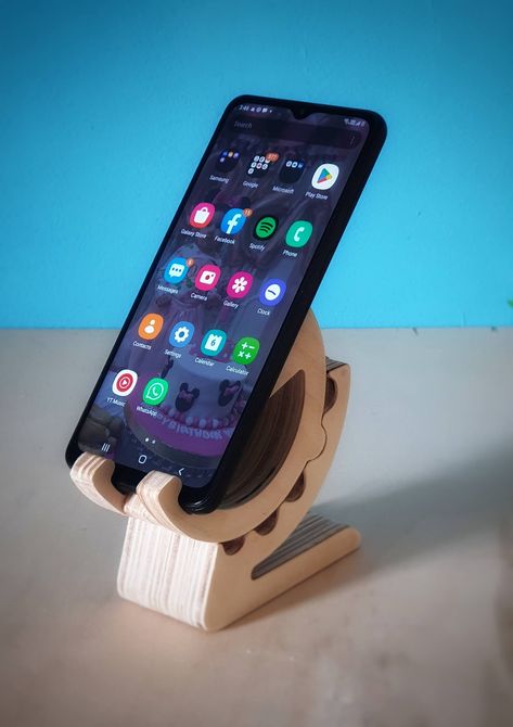 wooden mobile holder "Geared Style" made by CNC machine. Wooden Mobile holder fabricated using CNC Machine, pitch pine wood 11mm thick. The mobile holder is designed to hold the mobile in portrait or landscape view, and the angle steps (70, 48, 26, 4 degrees), the holder allows to maintain the mobile and connect the charger without any restrictions. Gear Stand, Pitch Pine, Wooden Mobile, Mobile Stand, Mobile Holder, Landscape View, Cnc Machine, Phone Holder, 3d Print