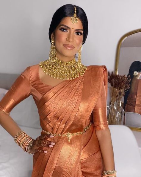 Toronto Makeup Artist on Instagram: "Absolutely radiant Dharshie, loved her @muhurtham__ saree that looked gorgeous in every single light. Couldn’t get enough of the terracotta & rose gold zari on her caramel complexion MUAH & Draping @imsylvie Saree @muhurtham__ Jewelry @mayasboutique Flowers @jasmineflorists . . . . . . . . . . . #torontomakeup #torontomakeupartist #torontomua #bridalmakeup #tamilmakeupartist #tamilmua #tamilbride #indianbride #southasianbride #tamil #weddingmakeupartis