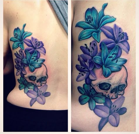 Skull and lily back tattoo. Colourful purple and blue lily with black and grey shade back tattoo. Skull And Lilies Tattoo, Purple Lillies Tattoo, Kindered Spirts, Blue And Purple Flower Tattoo, Purple And Blue Tattoo, Blue Lily Tattoo, Lily Back Tattoo, Tattoo Colourful, Daisies Tattoo