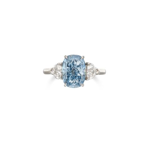 An Exquisite Fancy Vivid Blue Diamond and Diamond Ring Centering a cushion-cut Fancy Vivid Blue diamond weighing 3.01 carats, flanked by two heart-shaped diamonds weighing 0.41 carat each, size 6. Condition Report Catalogue note Accompanied by three GIA reports: no. 5201974368 dated July 22, 2020 stating that the center diamond is Fancy Vivid Blue, Natural color, VVS1 clarity. Together with a letter from the GIA stating that the diamond has been determined to be Type IIb. No. 2394294880 dated Blue Diamond Ring Engagement, Colored Diamond Jewelry, Blue Diamond Ring, Solitaire Rings, Cartier Jewelry, Heart Shaped Diamond, Two Hearts, Blue Rings, Blue Diamond