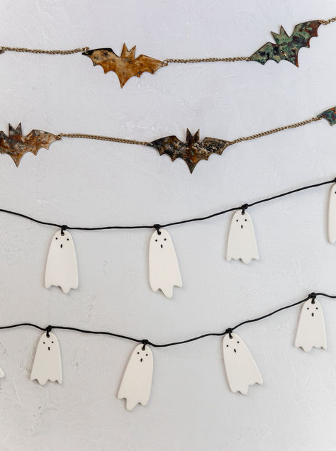 The Ceramic Ghost Garland is the perfect decor piece for your Halloween festivities! This three foot long strand of white ceramic ghosts features face details to give each one a cute, but eerie look. Design Tip: Multiple garlands will likely be needed for your mantel or staircase. Please measure your space and order accordingly. For a fuller look, double up garlands or add in faux stems! *Stock on our Fall Collection is limited.*Halloween items are eligible for returns until October 15th. Halloween Wall Classroom, Minimal Halloween Decor, Ceramic Ghosts, Halloween Decor Inspiration, Bat Garland, Glow Projects, Ghost Garland, Cottagecore Halloween, Apartment Halloween