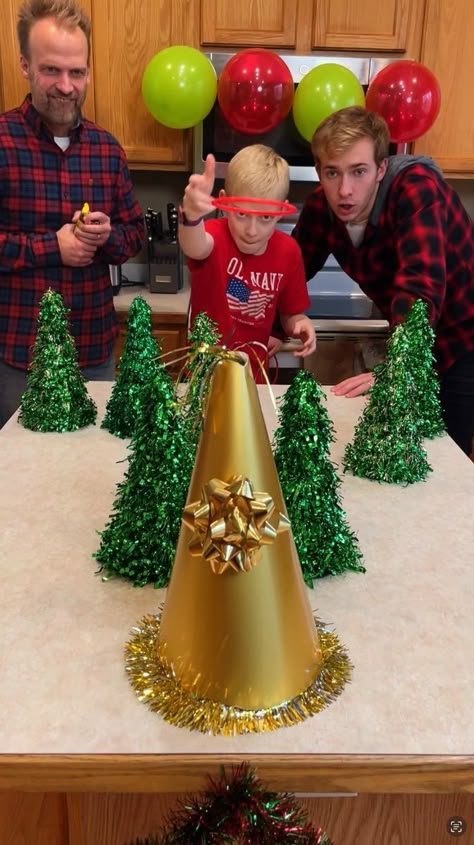 Christmas Tree Ring Toss Game 🎄 | Christmas Tree Ring Toss Game 🎄 Dad, mom, kids, and family play counter top Christmas tree ring toss game for fun prizes. Toss a ring on the golden... | By Benson Bros Reindeer Ring Toss Game, Christmas Ring Toss, Christmas Olympics, Benson Bros, Christmas Charity, Christmas Tree Ring, Carnival Night, Xmas Games, Fun Christmas Party Games