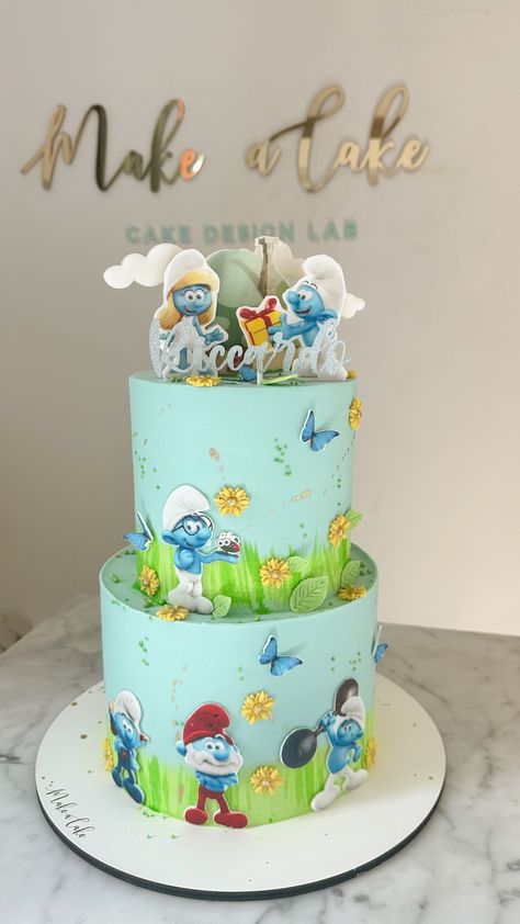 The Smurfs theme two-layer cake.  #CakeArt #CakeDesign #CakeDecor #BirthdayCake #TwoLayerCake #TheSmurfsCake Smurf Themed Birthday Party, Cake Smurfs, Smurf Birthday Cake, Smurf Theme, Smurfs Birthday, Smurfs Cake, Baby Boy Birthday Cake, Two Layer Cakes, Buttercream Cake Designs