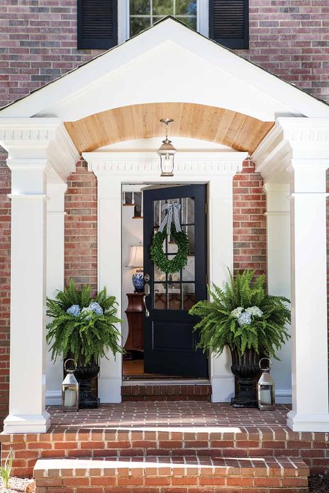 A Maryland Charmer Inspired by Waterfront Views - The Cottage Journal Navy Door, Boxwood Wreath Front Door, Boxwood Wreath Decor, Front Door Planters, Cottage Journal, Garage Door Makeover, Front Door Entrance, Boxwood Wreath, Wreath Hanger