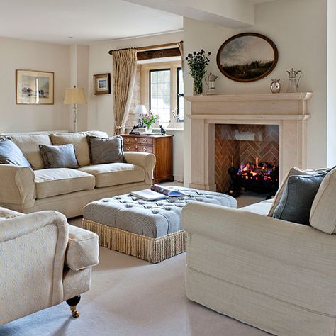 Neutral living room with neutral stone fireplace, cream sofas and pale blue ottoman Neutral Traditional Living Room, Living Room With Ottoman, English Cottage Living Room, Living Room Cream, Country Fireplace, Living Room Decor Country, Living Room Warm, Country House Interior, Living Room Photos