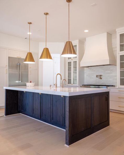 Harrison Homes on Instagram: “The rich, dark wood of the custom kitchen island contrasts beautifully with the light cabinets and backsplash. And, notice the brass…” Dark Stained Island White Cabinets, Dark Island Light Cabinets, Dark Island White Cabinets, Dark Brown Kitchen Island, Dark Wood Kitchen Island, Dark Stained Island, Dark Wood Island, Light Cabinets, Dark Island