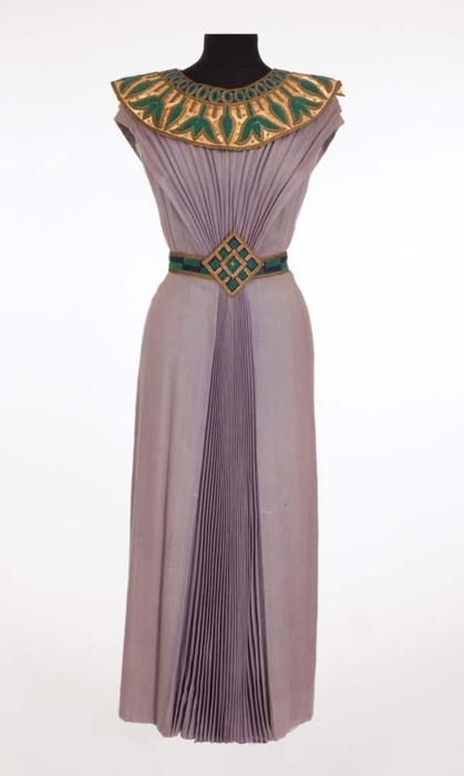 Dorothy  Kirsten “Louise Heggar” Egyptian dress from The Great Caruso. (MGM,  1951) Light purple wool Egyptian style dress with gold, blue and green  collar and belt.  Handwritten label “7663 1514 Dorothy Kirsten.”  Worn  by Dorothy Kirsten as “Louise Heggar” during the final trio “O terra,  addio” scene in the opera, Aida in The Great Caruso. Egyptian Style Dress, Ancient Egyptian Dress, Egyptian Inspired Fashion, Egypt Clothing, Ancient Egyptian Fashion, Egyptian Dress, Ancient Egypt Fashion, Egyptian Clothing, Egyptian Fashion