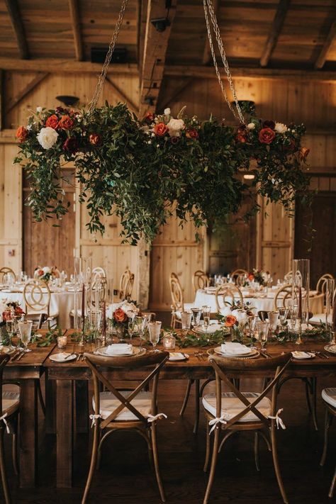 A rusty red floral installation was the focal point of this gorgeous wedding reception | Image by Jill Houser Photography Fall Floral Chandelier Wedding, Barn Wedding Chandelier, Hanging Greenery Wedding, Hanging Floral Wedding, Floral Installation Wedding, Flower Chandelier Wedding, Floral Chandelier Wedding, Hanging Floral Installation, Hanging Flowers Wedding