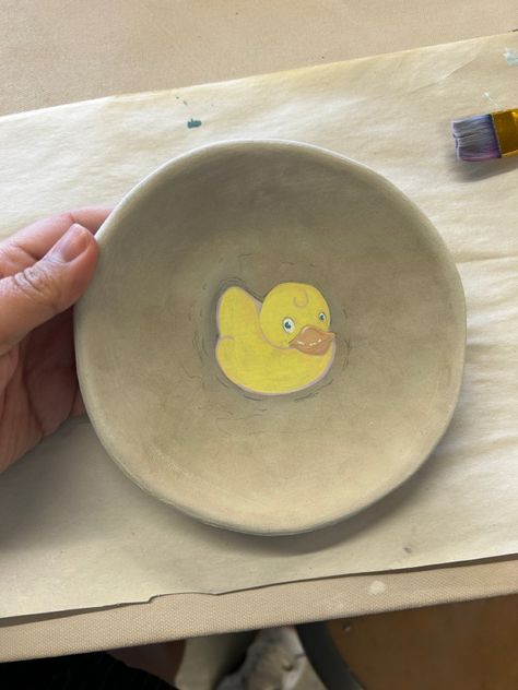 A round Bowl shaped unfired bisque wear ceramic dish with a painting of a cute rubber ducky in the middle. Ceramic Art Bowl, Duck Pottery, Pottery Painting Ideas Easy, Art Bowls, Hand Painted Pottery, Ceramic Ideas, Clay Art Projects, Bowl Designs, Rubber Ducky