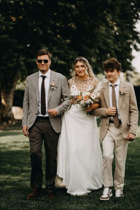 Bride walking down the aisle with her brothers | Image by Lukas Korynta Brother Walking Bride Down Aisle, Brother Of Bride Outfit, Brothers Walking Sister Down Aisle, Bride And Brothers Pictures, Brother Walking Sister Down Aisle, Brother Of The Bride Outfit, Brother Sister Photography, Brother Of The Bride, Bride Walking Down The Aisle