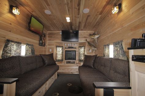 The interior of Mr. Larsen's fish house is shown. A fireplace tucked in a cozy alcove between a set of bay windows casts a glow on the tongue-and-groove cedar-paneled walls and ceiling. The couches fold out into a king-size bed. Ice Shanty Interior, Ice Castle Fish House, Ice Fishing Shack Plans, Shack Interior, Ice Fishing Shanty, Houseboat Ideas, Ice Fishing Sled, Ice Hut, Fishing House