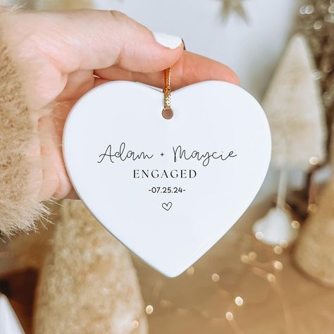 Our personalized couples engagement or newly married ornament will light up the holiday season. Personalize this as a gift for yourself, or give it to somebody special in your life. Our ornaments are made of ceramic and have a glossy finish. They measure 2.75" in diameter and include a gold string for hanging. Our ornaments are ready to gift and will arrive in a gift box! If you have any questions about ordering, please send us a message! ♥️NO CANCELLATIONS AFTER 12 HOURS OF ORDER PLACEMENT. PRO Engagement Gifts Newly Engaged, Engaged Ornament, Engagement Ornament, Christmas Engagement, Couples Ornaments, Married Ornament, Engagement Ornaments, Engagement Announcement, Newly Married