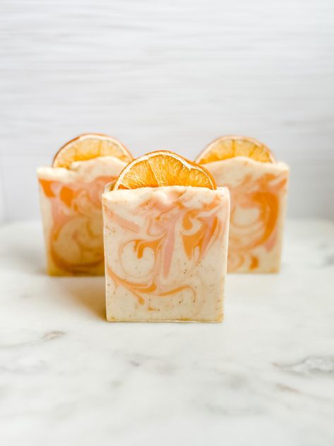 Fragrance Notes: Valencia Orange, Bergamot, Neroli Part of our Soap Lily Essentials Collection, this handcrafted soap smells so fresh and energizing! It contains orange peel powder for gentle exfoliation. Made with organic coconut oil, sweet almond oil, olive oil, Kaolin clay, and other skin-loving ingredients, this soap has a subtle, pleasant fragrance that is sure to bring a smily to your face and remind you of a sunny day! It is topped with a real dried orange slice that can be removed and discarded as you use the soap. Cold process soaps are cured for 4-6 weeks and can last up to a month with regular use. Soap bar weight is between 5.5 and 6 oz. Check out our other Sunny Citrus products! Vegan Friendly | Cruelty Free | Handmade Orange Homemade Soap, Silka Papaya Soap, Orange Hot Process Soap, Diy Soap Recipe, Dessert Soap, Orange Soap, Coconut Soap, Citrus Soap, Valencia Orange