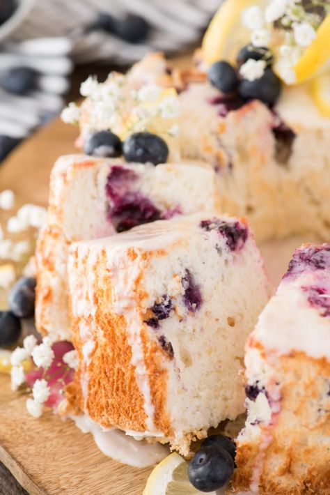 This homemade angel food cake is bursting with lemon and blueberries! There’s lemon zest and blueberries baked into the fluffy angel food cake and a fresh lemon glaze on top. We’ll show you how to make berry angel food cake without cake flour. Plus ALL THE TIPS for making homemade angel food cake and gluten free angel food cake too! #angelfoodcake #lemonangelfoodcake #angelfoodcakedesserts Angel Food Cake Glaze, Berry Angel Food Cake, Blueberry Angel Food Cake, Angel Food Cake Cupcakes, Angel Food Cake Trifle, Homemade Angel Food Cake, Gluten Free Angel Food Cake, Lemon Angel Food Cake, Angel Food Cake Desserts