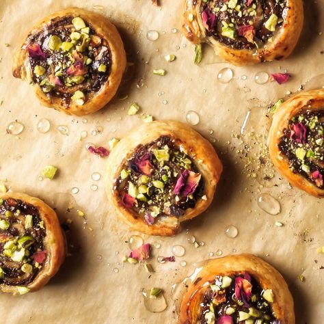 Puff-pastry pinwheels with a date and pistachio filling, soused with a rose-flavoured syrup and ... Pistachio Rose Croissant, Pistachio Filling, Pastry Pinwheels, Puff Pastry Pinwheels, Edible Rose Petals, Brie Puff Pastry, Crepes Filling, Edible Roses, Pistachio Cream