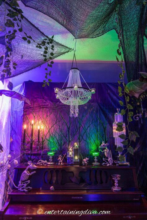 These Maleficent party decor ideas are awesome! From the enchanted forest to the lighting to the Maleficent cake, they would make an awesome Halloween party theme! #entertainingdiva #halloween #maleficentparty #halloweenindoordecor #halloweenscenesetters  #indoorhalloweendecorideas Halloween Scene Setters, Halloween House Party Decorations, Maleficent Cake, Halloween Candy Buffet, Adult Halloween Party Decorations, Maleficent Party, Green Christmas Lights, Halloween Decor Diy, Party Decor Ideas