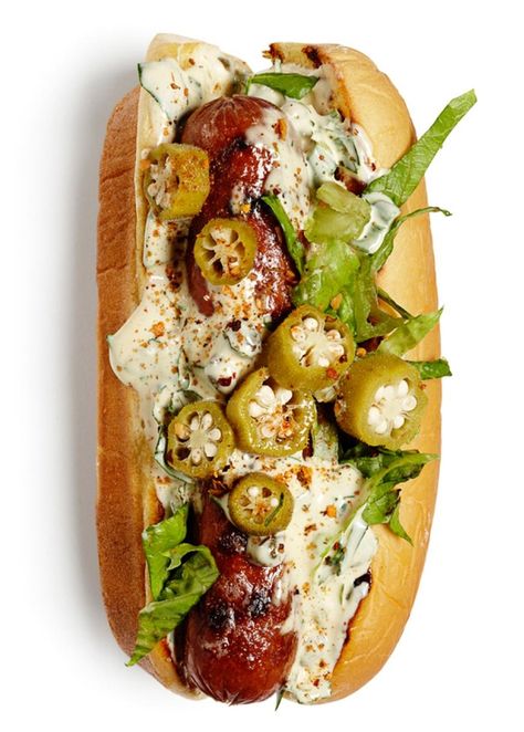 Grilled hot dogs on grilled buns with remoulade sauce or Creole mustard, shredded romaine and pickled okra. Sprinkle with Creole seasoning. Grilled Hot Dogs, Grilling Hot Dogs, Creole Mustard, Gourmet Hot Dogs, Hot Dogs Recipes, Hot Dog Toppings, Pickled Okra, Burger Dogs, Remoulade Sauce