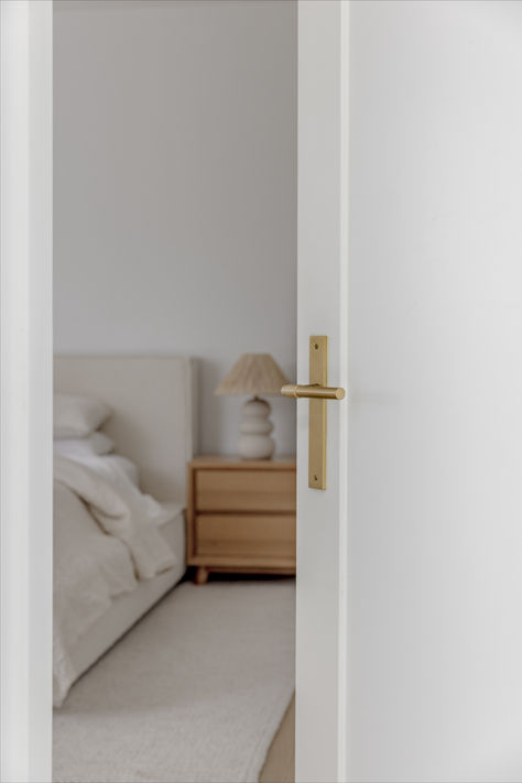 The Iver Helsinki Lever in Brushed Brass complements this white bedroom door beautifully, adding a touch of modern sophistication to its design. Together, they create a stylish and inviting entrance that enhances the overall aesthetic of the space. Brushed Brass Door Handles, Door Refresh, White Bedroom Door, Newport Beach House, Brass Door Handles, Cupboard Knobs, Door Lever, Cream Tones, Bedroom Door