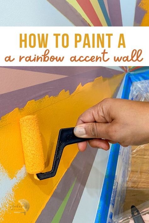 Not your traditional rainbow accent wall! Paint it in a corner. Use colors that match the room decor for a colorful sunburst rainbow accent wall that is modern and fun! #anikasdiylife Multi Colored Accent Wall, Playroom Wall Painting, Playroom Wall Paint Ideas, Rainbow Mural Kids Room Diy, Rainbow Paint Wall, Rainbow Painted Walls, Rainbow Wall Paint, Playroom Accent Wall, Rainbow Accent Wall