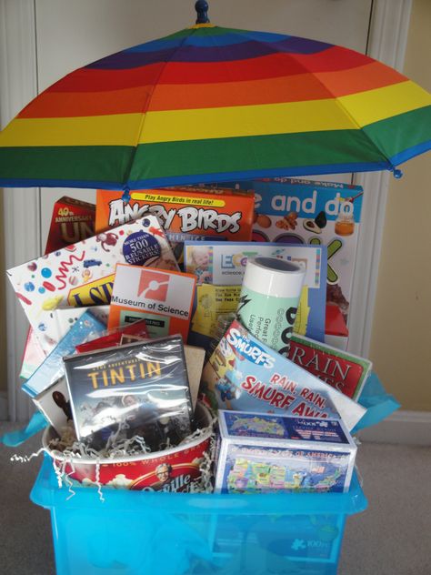 The "Rainy Day" Basket - 2012 - You won’t let a rainy day get you down with this basket of indoor activities!  Books, crafts, games, popcorn and “Adventures of Tin Tin” will help you pass the time at home.  You can even venture out to visit the Ecotarium or the Museum of Science.  This basket certainly won’t give you the rainy day blues. Rainy Day Raffle Basket, Rainy Day Basket Auction, Rainy Day Auction Basket Ideas, Adventure Basket Gift Ideas, Rainy Day Gift Basket, Rainy Day Basket, Silent Auction Gift Basket Ideas, Silent Auction Basket, Basket Raffle