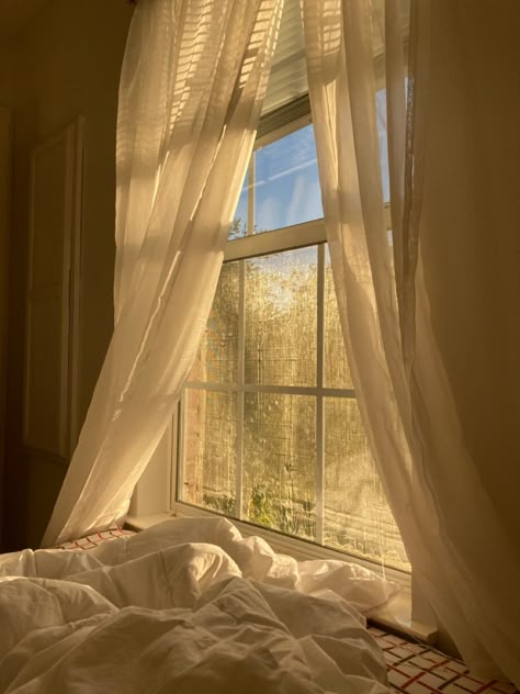 Heavenly Bedroom Aesthetic, Bed In Front Of Window Aesthetic, Sunlight Bedroom Aesthetic, Flowy Curtains Aesthetic, Bed Under Window Aesthetic, Warm Lit Bedroom, Morning Window Aesthetic, Aesthetic Bedroom Curtains, Cute Curtains Bedroom Aesthetic