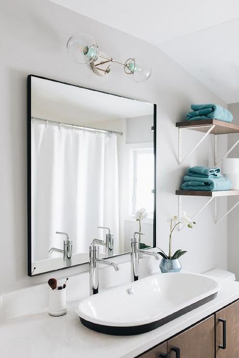 Black box frame mirror above a vintage oval sink with two chrome faucets on a white quartz countertop in a cottage bathroom design. Melanie Turner Interiors, Contemporary Bathroom Lighting, Above Sink, Black And Gold Bathroom, Natural Stone Countertops, White Shiplap Wall, Bathroom Black, Cottage Bathroom, Spa Like Bathroom