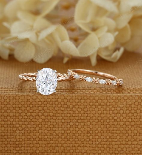 Oval Moissanite engagement ring set Two Tone 14K gold twist engagement ring Half eternity Marquise cut vintage ring Bridal Promise gift ring ITEM DESCRIPTION: Center stone: Oval cut Moissanite ( D color, VS clarity) Size: 7*9mm Side stone: 0.1ct moissanite  Width of band: 1.6mm Thickness of band: 1.6mm Total weight: 1.9g Wedding band: 0.2ct moissanite Width of band: 1.5mm Thickness of band: 1.1mm Total weight: 1.2g Materials (can select from drop-down menu): 14K Solid gold/ 18K Solid gold ( Rose Oval Wedding Ring Set 1.5 Carat, Twisted Wedding Band Set, Yellow Gold Oval Promise Ring, Oval Engagement Ring With Twisted Band Gold, Yellow Gold Oval Engagement Ring Stack, Gold Band Oval Engagement Ring, Oval Yellow Gold Moissanite Ring, Yellow Gold Oval Bridal Set, Twisted Band Engagement Ring