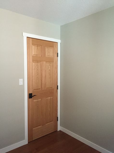 White Trim With Wood Doors Grey Walls, Indoor Door Trim Ideas, White Trim Oak Doors, Staining Trim, Wood Doors White Trim, White Window Trim, Painting Wood Trim, White Baseboards, Paint Trim