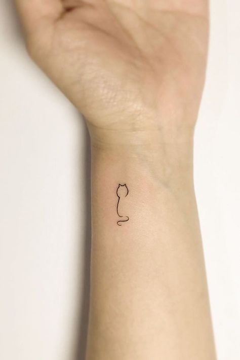 Small Minimalist Tattoo Design For Wrist #wristtattoo #cattattoo Tattoos For Women 2024, Cat Wrist Tattoos For Women, 31 Small Tattoos With Big Meanings, Tiny Cat Tattoos For Women, Cat Tattoo Wrist, Mimalistic Tattoo, Minimalist Tattoo Cat, Minimalist Tattoo Ideas Creative, Minimalist Tattoo Ideas Women