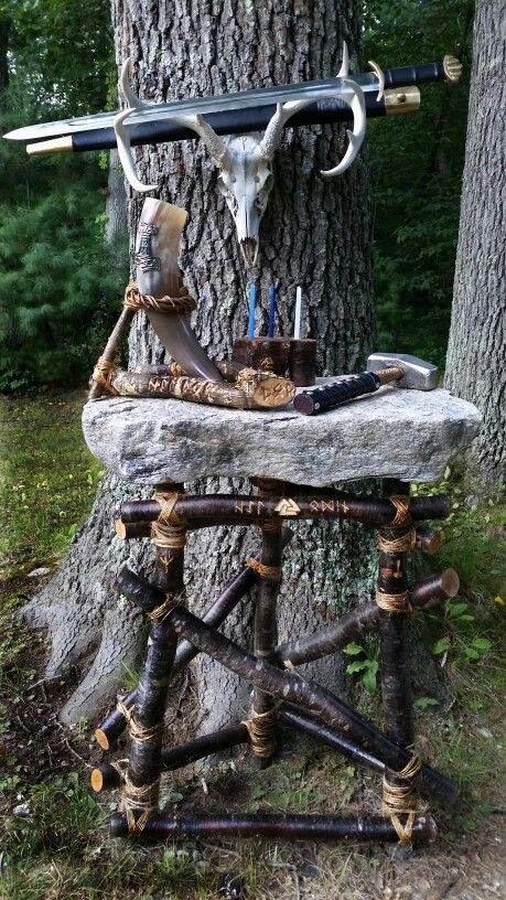 Odinist Ritual Area - 5...Odinist altar prepared for a general ritual. The granite slab rests on a wooden framework I made; the upper horizontal bar is engraved with the Runes, "Hail Odin" and Valknut, the left upright with the Elhaz Rune, the right with the Mjolnir Rune. The Trinkhorn with Thor's Hammer symbol rests in a wooden stand, engraved with the Runes, "Hail Thor," and "Thor." A wooden candle-holder/incense-holder is engraved with the powerful Triskelion Rune. Mjolnir is at the right on Norse Paganism Altar, Norse Pagan Alter, Norse Pagan Altar Inspiration, Lokean Altar, Thor Altar, Asatru Altar, Viking Altar, Elhaz Rune, Odin Altar