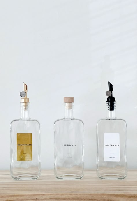 Introducing our Minimal Mouthwash Bottles, a stylish and versatile storage solution for your bathroom.  Choose between purchasing the bottles with or without labels. If you opt for labels, rest assured that we can print anything you desire on these high-quality waterproof labels, ensuring durability and longevity. These bottles are available in 2 sizes: 200 ml:  65 x 45 x 179 mm 500 ml:  88 x  45 x 220 mm  (length x width x height) Measurements do not include pourers, which are approx 5-7cm  To complete the customization process, select the lid of your choice from our range of options. Please refer to the product photos to view all available choices, including: - Black Drizzler - Clear Drizzler - Black Plastic Lid - Natural Wood Lid - Dark Wood Lid - Yellow Gold Weighted Pourer - Light Gol Glass Containers For Bathroom, Soap Dispenser Aesthetic, Shower Bottles, Bathroom Bottles, Mouthwash Dispenser, Room Vanity Ideas, Color Vibe, Waterproof Labels, Home Organisation