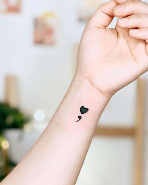 Small Heart Semicolon Wrist Idea Small Heart And Butterfly Tattoo, Small Semicolon Tattoo Wrist, Hidden Semi-colon Tattoo, Heart Semicolon Tattoo, Semicolon Wrist Tattoo, Tattoo Ideas Meaning, Semicolon Tattoo Ideas, Just Breathe Tattoo, Heart Semicolon