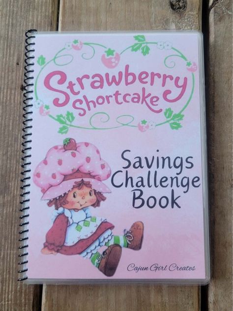 Check out the Strawberry Shortcake Savings Challenge Book! Packed with 12 pages of sweet Shortcake fun - from scratch and save, color your heart out, and dive into some dice games. And guess what? Everything is pretty in pink! This book is a A5. Slow Gin Fizz, Strawberry Kitchen, Strawberry Shortcake Doll, Hello Kitty Iphone Wallpaper, Dice Games, Pink Girly Things, Savings Challenge, Strawberry Shortcake, Personal Finance