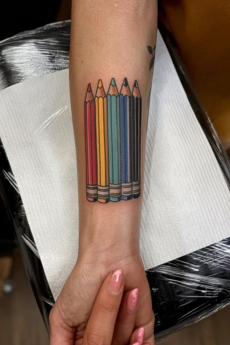 Forearm tattoo featuring colorful pencils lined up in a row. Small Wrist Tattoos For Women, Small Wrist Tattoo Ideas, Small Wrist Tattoo, Pencil Tattoo, Unique Wrist Tattoos, Wrist Tattoo Ideas, 2b Pencil, Dainty Flowers, Small Wrist Tattoos