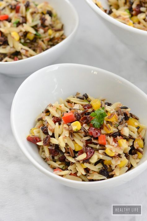 Wild Rice Orzo Cranberry Salad is a robust salad with layer upon layer of flavors. Wild Rice, Orzo, Wheat Berries are topped with currants, almonds, and dried cranberries tossed with bell peppers and fresh herbs add freshness to this hearty salad that is dressed with a champagne vinaigrette. | ahealthylifeforme.com Salad Cranberries, Superfood Breakfast Bars, Cranberry Salad Recipes, Superfood Breakfast, Wild Rice Salad, Cooking Wild Rice, How To Cook Orzo, Cranberry Salad, Orzo Salad