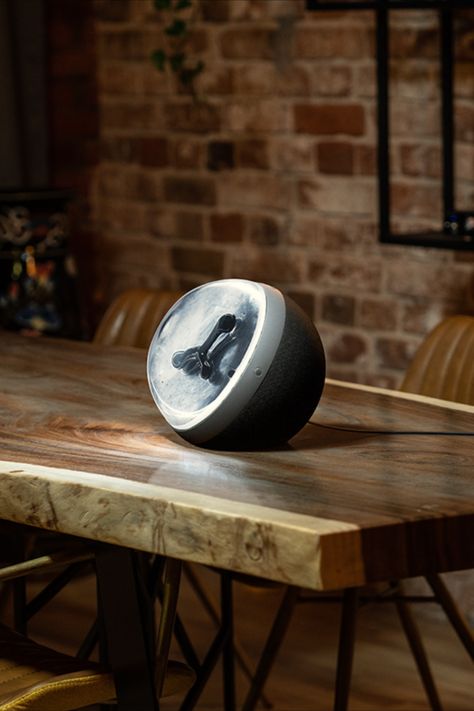 Sphere shaped speaker on wooden desk in front of brick wall Sensory Experience, Visual Display, Speaker, Van