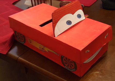 Lightning McQueen Valentine's Day card box. Printed decal on sticker paper, glue and red paint. Cars Valentine Box Ideas, Lightning Mcqueen Valentines Boxes, Monster Jam Valentine Box Ideas, Lightning Mcqueen Valentines, Car Valentine Box Ideas, Boy Valentines Boxes Diy, Birthday Card Holder, Disney Cars Theme, Cardboard Box Car