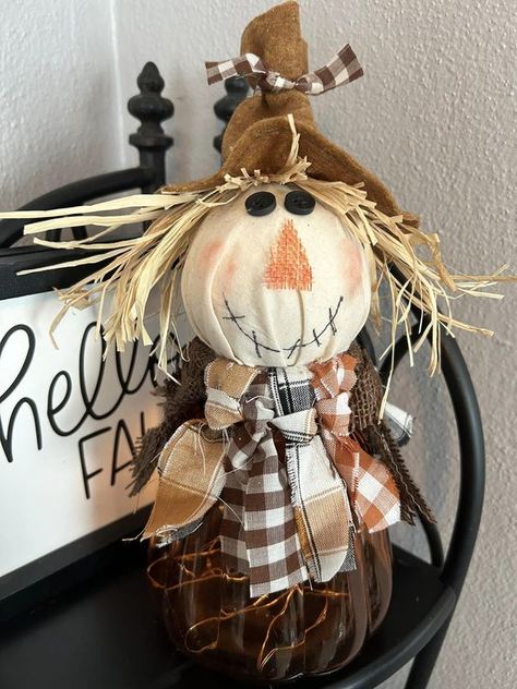 Dollar Tree Fantastics Crafts & Decor | DT pumpkin shape glass jar, fairy lights, styrofoam ball and fabric and felt to make this scarecrow. | Facebook Jar Fairy Lights, Fall Scarecrows, Crafts Decor, Styrofoam Ball, Glass Pumpkins, Tree Crafts, Dollar Tree Crafts, Jar Crafts, Scarecrow