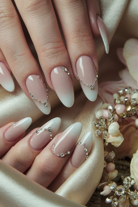 Elevate your nail game this season with these stunning almond nails adorned with delicate rhinestones. This chic design pairs perfectly with any outfit, making it a versatile choice for a night out or a casual day. The fusion of the almond shape with sparkling rhinestones creates a classy look that’s both pretty and edgy. Embrace this trendy style for Fall, and enjoy the fun of flaunting your nails! #AlmondNails #NailDesigns #NailInspo #TrendyNails Almond Shape Elegant Nails, Classy Gem Nails, Elegant Nails With Rhinestones, Nails With Gems On Them, Nude Almond Nails With Rhinestones, Almond Nails With Bling, Wedding Nails Rhinestone, Elegant Prom Nails, Almond Nails With Rhinestones