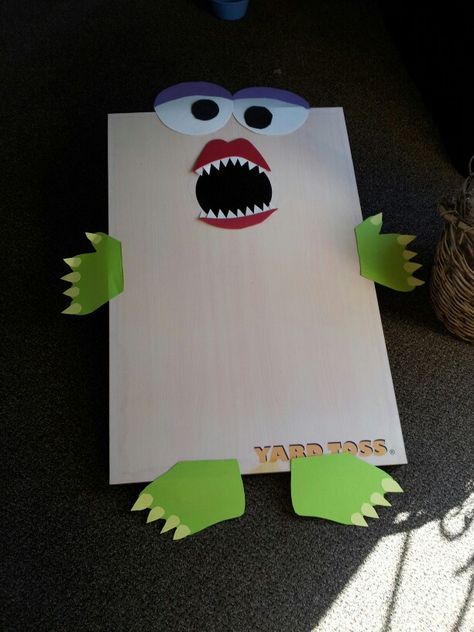 Halloween bean bag toss corn hole cornhole. Bean bags were in a basket labeled monster food at a Halloween party Corn Hole Halloween Game, Halloween Corn Hole, Halloween Party Preschool, Halloween Bean Bag Toss, Halloween Cornhole, Preschool Halloween Party, Church Halloween, Fest Ideas, Monster Food