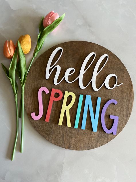 "This colorful Spring sign is perfect for any mantle, wall, or desk area. This beautiful and well made Spring sign is colorful and will be a great addition to your spring and Easter decor. It can also be a great gift.  Product info:  10.5 diameter wooden circle  1/4\" maple plywood round 1/4\" wooden colorful letters to make it 3D  Sealed for more protection" Hello Spring Sign, Personalized Easter Eggs, Spring Wall Decor, Easter Wood Crafts, Wooden Circle, Easter Basket Tags, Desk Area, Maple Plywood, Summer Signs