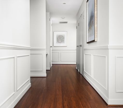 A hallway is an experience – a quiet journey that connects spaces, creating a flow throughout your home. It’s not just a transitional area; it’s a path that sets the tone, directing you where to go and how to feel as you move through it. Now, let’s talk about wainscoting. It’s not just about adding a decorative feature; it’s about bringing that hallway to life. With wainscoting, the walls aren’t just there to hold up the roof – they become part of the journey, Adding depth, character, And... Wainscoting Small Hallway, Hallway With Wainscoting, Wainscoting Hallway Ideas, Hallway Molding Ideas, Hallway Wainscotting, Wainscoting Hallway, Wainscoting Ideas, Painted Wainscoting, White Hallway