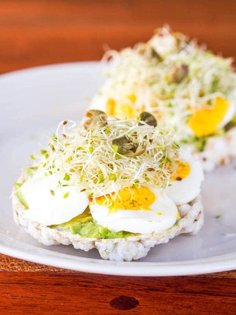 Perfect in its simplicity – open faced rice cake toasts topped with soft avocado, hard boiled eggs, fresh alfalfa and salty capers. A gluten free and dairy free breakfast ready in minutes. #breakfast #avocado #healthy #egg #glutenfree Rice Cakes Toppings, Rice Cake Recipes, Avocado Pesto, Dairy Free Breakfasts, Toast Toppings, Breakfast Cake, Egg Salad, Hard Boiled, Rice Cakes