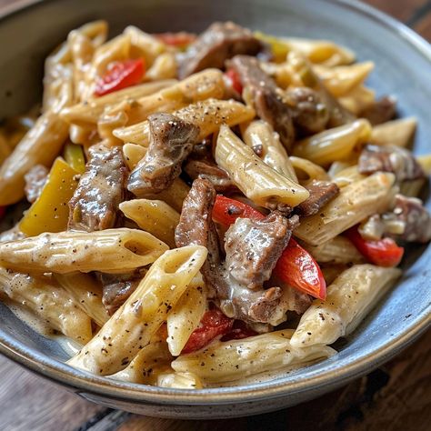 🍝🧀 Dive into comfort with our Cheesesteak Penne in Provolone Cheese Sauce! 🍝🧀 #PastaLovers #CheesyDelight Cheesesteak Penne in Provolone Cheese Sauce Ingredients: Penne pasta (2 cups) Beef strips (1 lb) Onion, sliced (1) Bell peppers, sliced (2) Provolone cheese, shredded (2 cups) Heavy cream (1 cup) Olive oil (2 tbsp) Garlic, minced (3 cloves) Salt and pepper to taste Instructions: Cook penne pasta according to package instructions; drain. In a skillet, heat olive oil and sauté garlic, o... Provolone Cheese Sauce, Best Freeze Dried Food, Beef Strips, Twisted Recipes, Cheesy Pasta, Quick Recipes Snacks, Healthy Food Dishes, Provolone Cheese, Trending Recipes