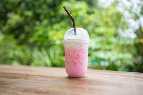 Pink strawberry milk pink ice drink in plastic cup juice for summer and straw on wooden table with nature Photo | Premium Download Pink Drink Starbucks, Strawberry Acai Refresher, Ice Drink, Soda Cup, Strawberry Acai, Strawberry Drinks, Ice Milk, Popular Drinks, Pink Drink