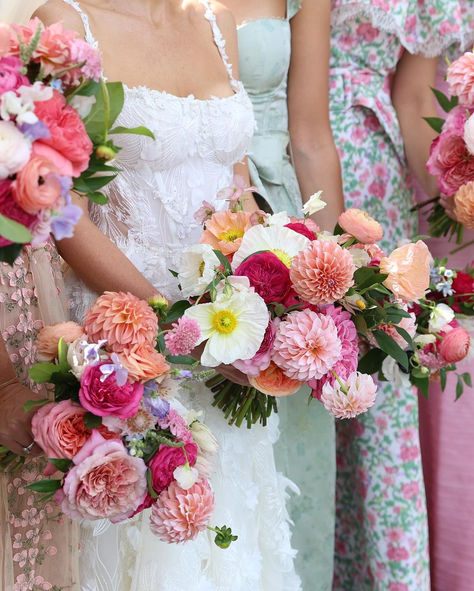 This elegant floral arrangement bursts with vibrant, garden-inspired blooms. Set against a stunning lace wedding gown, the bouquet features bold pink and coral dahlias, delicate poppies, and whimsical roses, all woven together to create a joyful and romantic bridal look. Add a touch of fresh, natural beauty to your wedding with lush flowers that bring both color and charm to your day! Vibrant Wedding, Lace Wedding Gown, Bridal Look, Wedding Gowns Lace, Garden Inspired, Elegant Floral, Floral Arrangement, Bridal Looks, Wedding Bouquet