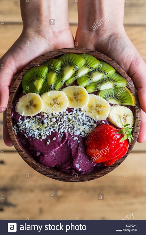 Download this stock image: Acai bowl in hands - Bowl of acai purée with toppings of banana, kiwi, strawberry and seeds. - KXP9A4 from Alamy's library of millions of high resolution stock photos, illustrations and vectors. Benefits Of Acai, What Is Acai, Acai Benefits, Acai Puree, Kiwi Berries, Kiwi Strawberry, Acai Smoothie Bowl, Acai Smoothie, Acai Berry