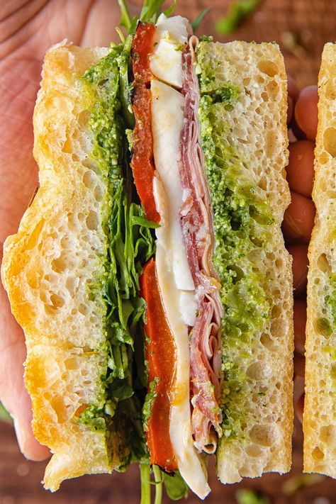 Turn your focaccia into an Italian sandwich. Layer your bread slices with cured deli meats, cheese, and pesto for the ultimate jaw-dropper. Focaccia Bread Sandwich, Deli Sandwiches Recipes, Italian Sandwich Recipes, Focaccia Sandwich, Cold Cut Sandwich, Pesto Sandwich, Picnic Sandwiches, Vegan Sandwiches, Sourdough Sandwich